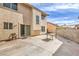 Backyard featuring a concrete patio, stucco wall, and two story home with a sliding glass door at 2727 Scotch Heather St, Las Vegas, NV 89142