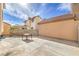 Backyard featuring a concrete patio, block walls, and stucco exterior of a two story home at 2727 Scotch Heather St, Las Vegas, NV 89142