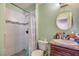 Bathroom featuring a tile shower, round mirror, toilet, and vanity with a granite countertop at 2727 Scotch Heather St, Las Vegas, NV 89142