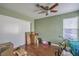 This bedroom features wood floors, a ceiling fan, a window with blinds, and a closet with sliding doors at 2727 Scotch Heather St, Las Vegas, NV 89142