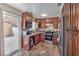 Well-equipped kitchen with stainless steel appliances, granite countertops, and ample dark wood cabinets at 2727 Scotch Heather St, Las Vegas, NV 89142