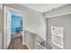 Hallway landing with natural light, railing overlooking the living area and view of the room to the left at 2727 Scotch Heather St, Las Vegas, NV 89142