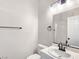 Bright bathroom featuring a single sink, white vanity, and a framed mirror at 283 Fancrest St, Henderson, NV 89052