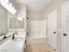 Bright bathroom with tiled floors, a shower-tub combo, and modern fixtures at 283 Fancrest St, Henderson, NV 89052