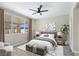 Staged bedroom features a large window with backyard views and plush carpet flooring at 283 Fancrest St, Henderson, NV 89052