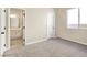 Bedroom view with carpet, window, and a partial view of the on-suite bathroom at 283 Fancrest St, Henderson, NV 89052