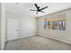 Neutral bedroom with ceiling fan, plush carpeting, and window view at 283 Fancrest St, Henderson, NV 89052