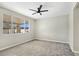 This bedroom features a large window with backyard views and plush carpet flooring at 283 Fancrest St, Henderson, NV 89052