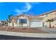 Charming single-story home with a well-maintained front yard, desert landscaping, and an attached two-car garage at 283 Fancrest St, Henderson, NV 89052