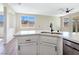 Kitchen island with stainless steel appliances, modern fixtures and a view of the connected living spaces at 283 Fancrest St, Henderson, NV 89052