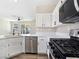 Kitchen with stainless steel appliances, white cabinets, and a view of the backyard pool at 283 Fancrest St, Henderson, NV 89052