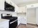 Close up of a kitchen with stainless steel oven, white cabinets, and stone countertops at 283 Fancrest St, Henderson, NV 89052