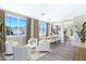 Bright living and dining room with a modern design, large windows, and wood-look floors at 283 Fancrest St, Henderson, NV 89052