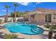 Inviting backyard pool with a spa, covered patio and lush landscaping, perfect for relaxation and entertainment at 283 Fancrest St, Henderson, NV 89052