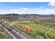 Scenic aerial view of a golf course surrounded by desert landscape with mountain views in the background at 3 Hilltop Crest St, Henderson, NV 89011