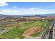 Expansive aerial view of a lush golf course community featuring desert landscape and mountain views at 3 Hilltop Crest St, Henderson, NV 89011