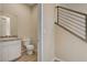 This half bathroom features a granite countertop, white cabinetry, a white toilet, and tile floors at 3 Hilltop Crest St, Henderson, NV 89011