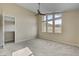 This bedroom has a ceiling fan, neutral carpet and paint with a large window allowing natural light at 3 Hilltop Crest St, Henderson, NV 89011