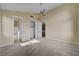 This bedroom features neutral walls, carpet, a ceiling fan, and views into the ensuite bathroom at 3 Hilltop Crest St, Henderson, NV 89011