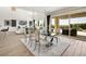 Bright dining room with large glass table and modern chairs near sliding doors at 3 Hilltop Crest St, Henderson, NV 89011