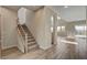 View of the tiled entryway, staircase, and open-concept living space with natural light, and modern fixtures at 3 Hilltop Crest St, Henderson, NV 89011