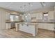 Bright kitchen featuring granite counters, wood floors, a large island, and stainless steel appliances at 3 Hilltop Crest St, Henderson, NV 89011