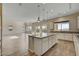 Open concept kitchen with an island, granite countertops, and seamless flow into the living space at 3 Hilltop Crest St, Henderson, NV 89011