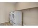 Laundry room with tile flooring, a shelf, and modern washer and dryer units at 3 Hilltop Crest St, Henderson, NV 89011