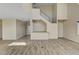 Living room with modern staircase, wood-look floors, and recessed lighting at 3 Hilltop Crest St, Henderson, NV 89011