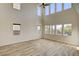 Bright living room with high ceilings, many windows, and wood-look floors at 3 Hilltop Crest St, Henderson, NV 89011