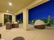 Covered patio with pool and seating area at night at 3 Hilltop Crest St, Henderson, NV 89011