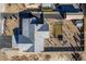 Aerial view of home featuring grey roof, gravel landscaping, and lovely backyard amenities at 3101 S Spy Glass Ave, Pahrump, NV 89048