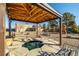 Backyard boasts a charming water feature, covered patio, and mature trees creates a serene outdoor space at 3101 S Spy Glass Ave, Pahrump, NV 89048