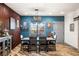 Dining area with rustic wood table, decor, and bright, contrasting blue wall at 3101 S Spy Glass Ave, Pahrump, NV 89048