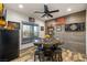 Rustic dining area features a barrel table, wood-look floors, accent wall and a large window at 3101 S Spy Glass Ave, Pahrump, NV 89048