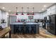 Spacious kitchen featuring gray cabinets, a large center island with seating, and modern stainless steel appliances at 3101 S Spy Glass Ave, Pahrump, NV 89048