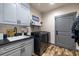 Laundry room with gray cabinets at 3101 S Spy Glass Ave, Pahrump, NV 89048