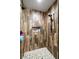 Modern shower featuring wood-look tile, niche for storage, and a rainfall shower head at 3101 S Spy Glass Ave, Pahrump, NV 89048