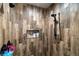 Modern shower with wood-look tile and niche for storage, and a rainfall shower head at 3101 S Spy Glass Ave, Pahrump, NV 89048