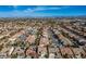 Expansive aerial view showcasing a residential neighborhood, a backdrop of mountains and a visible skyline at 3146 Surf Spray St, Las Vegas, NV 89117