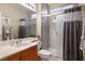 Well-maintained bathroom featuring a glass-enclosed shower, a tile surround, and a mirrored vanity at 3146 Surf Spray St, Las Vegas, NV 89117