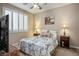 Comfortable bedroom featuring a ceiling fan, neutral walls, and natural light from the shuttered window at 3146 Surf Spray St, Las Vegas, NV 89117