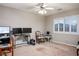 Bedroom with neutral walls, a ceiling fan, plantation shutters, and several workspaces with computer monitors at 3146 Surf Spray St, Las Vegas, NV 89117