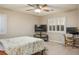 Bright bedroom featuring a ceiling fan, neutral walls, and plantation shutters at 3146 Surf Spray St, Las Vegas, NV 89117