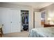 Neutral bedroom features large closet and a doorway leading to a staircase, a dresser, and bed at 3146 Surf Spray St, Las Vegas, NV 89117