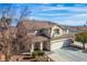 A well-kept two-story house, featuring a two-car garage, a tiled roof, and a beautifully landscaped front yard at 3146 Surf Spray St, Las Vegas, NV 89117