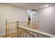 Upstairs hallway featuring wooden railing and neutral-colored walls leading to various rooms at 3146 Surf Spray St, Las Vegas, NV 89117