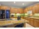 A view of the kitchen with wooden cabinets, granite countertops and stainless steel appliances at 3146 Surf Spray St, Las Vegas, NV 89117