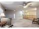 Open living room featuring a ceiling fan, neutral walls, and staircase with wooden banister at 3146 Surf Spray St, Las Vegas, NV 89117