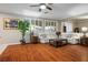 Cozy living room with hardwood floors, a ceiling fan, and lots of natural light at 3146 Surf Spray St, Las Vegas, NV 89117